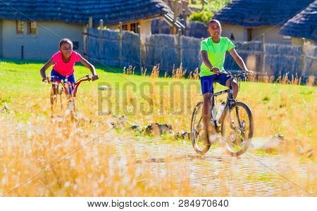 African Children Riding A Bike In Rural A Village