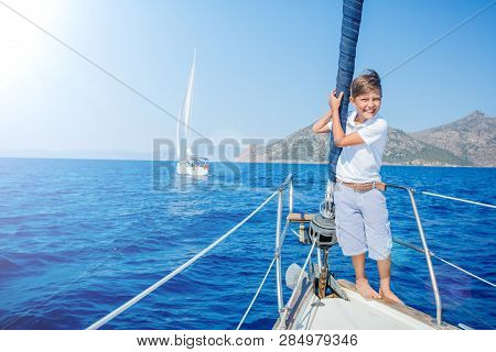Little Boy On Board Of Sailing Yacht On Summer Cruise. Travel Adventure, Yachting With Child On Fami