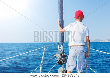 Little Boy On Board Of Sailing Yacht On Summer Cruise. Travel Adventure, Yachting With Child On Fami