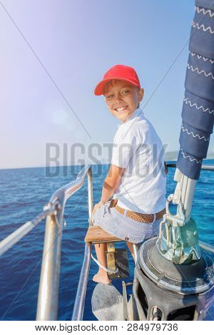 Little Boy On Board Of Sailing Yacht On Summer Cruise. Travel Adventure, Yachting With Child On Fami