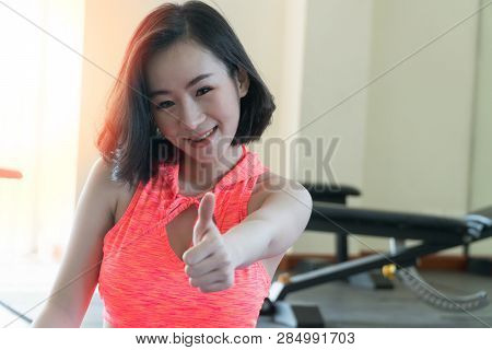 Health Care Healthy Lifestyle Concept. Attractive Young Woman Showing Thumbs Up After Workout In Gym