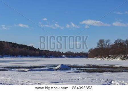 White snow on a small river in Russia in winter
