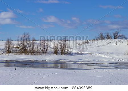 White snow on a small river in Russia in winter