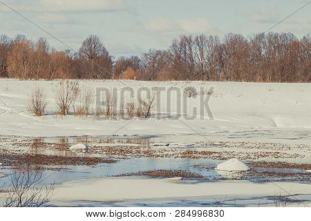 White snow on a small river in Russia in winter