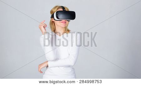 Amazed Young Woman Touching The Air During The Vr Experience. Portrait Of An Amazed Girl Using A Vir
