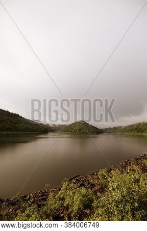 Mirror Smooth Water Of The Carpathian Zetelaka Lake. Beautyful Landscape After Rain