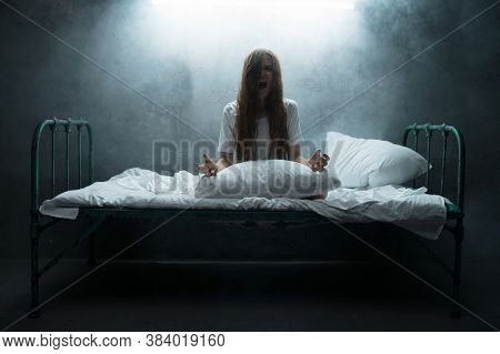 Psycho woman screams in bed, insomnia horror