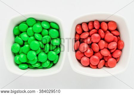 Two Squared Bowls With Small Green And Red Coated Chocolate Candies Similar To M&ms In A Squared Bow