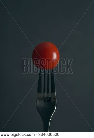 Round Red Cherry Fresh Tomato On The Fork