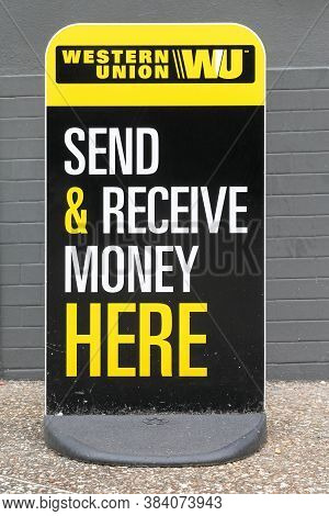 Tarare, France- June 27, 2020: Western Union Sign And Point. The Western Union Company Is An America