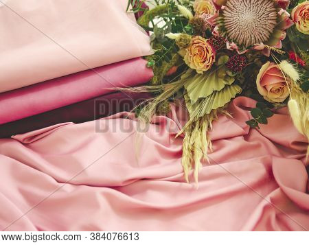 Close Up Picture Of Pink Silk Fabric And Bouquet Of Flowers On The Side, As Greeting Card In Pink Sh