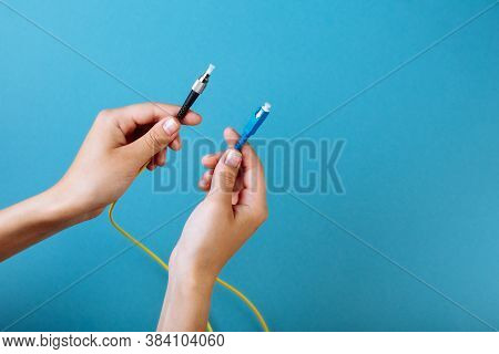 Womans Hands Hold Sc And Fc Connector Fiber Optic Patch Cord Single Mode On Blue Background