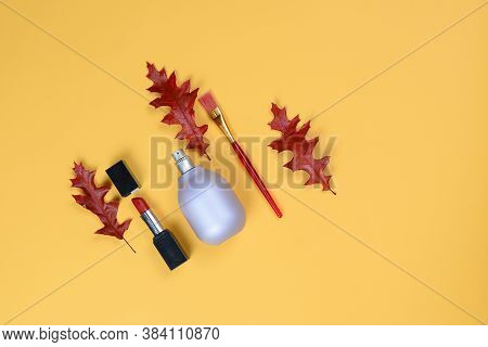 Perfume Bottle Lavender-colored,lipstick,bruch Lies Beautifully On A Yellow Background With Orange T