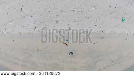 Sandy Beach With Plastic Garbage And Medical Waste Materials In Tropical Beach With Emerald Clear Se