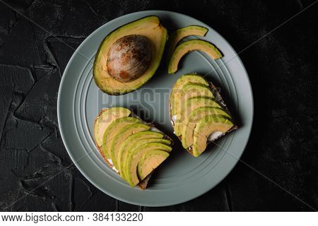 Avocado Sandwiches On A Plate Top View. Vegetarian Food