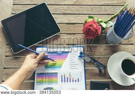 Office Laptop Business Financial Document Chart And Graph On Wooden Table With Coffee Cup. Flat Lay 