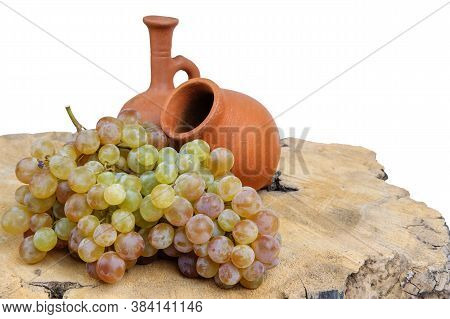 Georgian Traditional Decorative Jugs For Wine Qvevri And Doki With Grape On The Wooden Log Slice Wit
