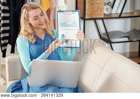 Smiling Pretty Young Financial Manager Showing Digram She Was Working On When Video Calling Her Coll