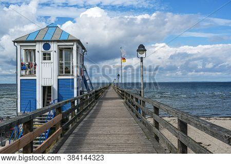 Lifeguard Station House At The Sea-bridge Of Lubmin Under A Blue Sky With Clouds, Seaside Tourist Re
