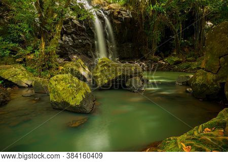 Tropical Landscape. Beautiful Hidden Waterfall In Rainforest. Adventure And Travel Concept. Nature B
