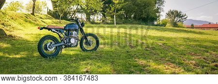Beautiful Vintage Custom Motorcycle Parked On The Field