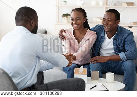 Marriage Reconciliation. Happy Black Couple Grateful To Family Counselor After Successful Therapy, S