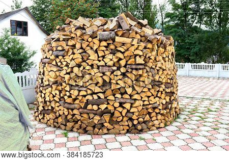Heap Of Firewood Stacked In The Yard