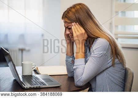Young Modern Woman Is Working From Home. She Is Having Headache.