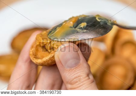 Filling The Halves Of Cookie Nuts With Boiled Condensed Milk. Women's Hands Fill Cookies With Boiled