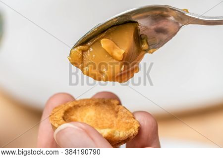 Filling The Halves Of Cookie Nuts With Boiled Condensed Milk. Women's Hands Fill Cookies With Boiled