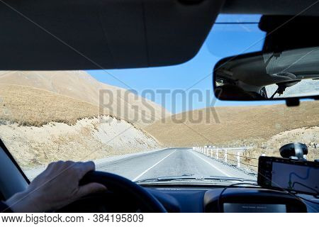 Tbilisi, Georgia - October 25, 2019: Car Vindow, Hand Of Woman On Steering Wheel And View To The Roa