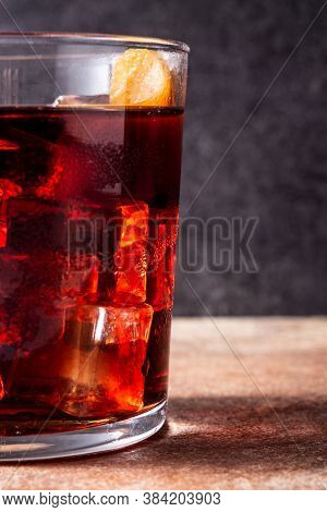 Boulevardier Cocktail And Orange Zest On Rusty Background