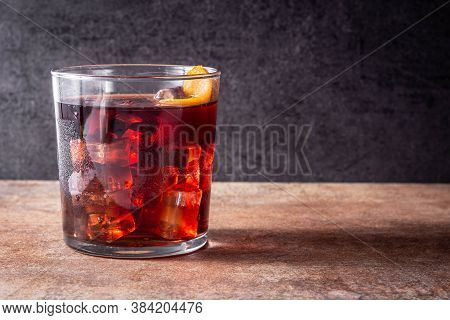 Boulevardier Cocktail And Orange Zest On Rusty Background. Copy Space