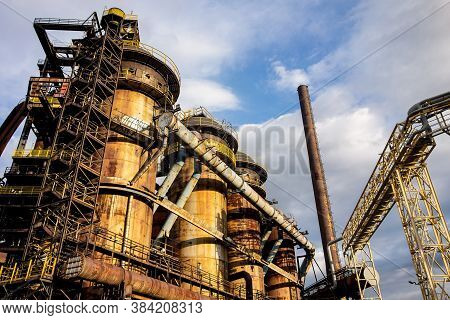 Old Rusty Industry Pipes And Buildings In Ostrava Vitkovice Region At Sunset With Blue Sky