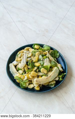 Sliced Artichoke With Broad Beans, Purslane Salad, Grated Parmesan Cheese And Olive Oil.