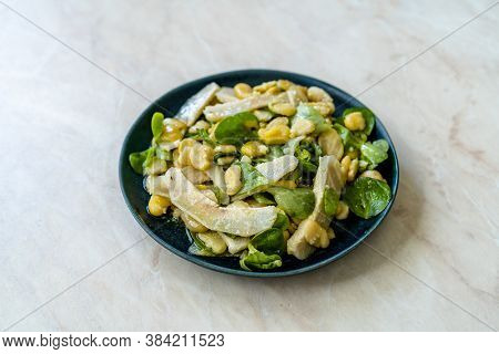 Sliced Artichoke With Broad Beans, Purslane Salad, Grated Parmesan Cheese And Olive Oil.