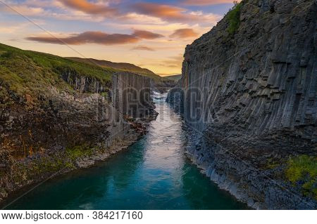 Studlagil Canyon With The Jokulsa A Bru River In East Iceland Photographed At Sunset.