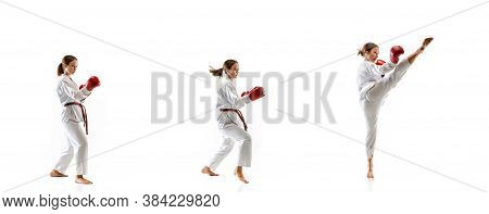 Kicking. Junior In Kimono Practicing Taekwondo Combat, Martial Arts. Young Female Fighter With Red G