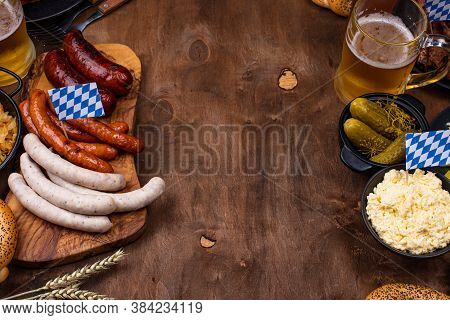 Oktoberfest Dishes: Beer, Pretzel, Sausage, Stewed Cabbage, Potato Salad, Half Of Chicken And Ribs