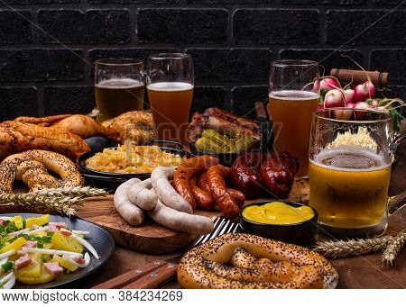 Oktoberfest Dishes: Beer, Pretzel, Sausage, Stewed Cabbage, Potato Salad, Half Of Chicken And Ribs