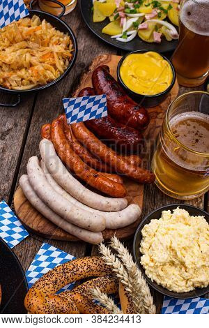 Oktoberfest Dishes: Beer, Pretzel, Sausage, Stewed Cabbage, Potato Salad, Half Of Chicken And Ribs