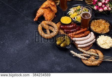 Oktoberfest Dishes: Beer, Pretzel, Sausage, Stewed Cabbage, Potato Salad, Half Of Chicken And Ribs