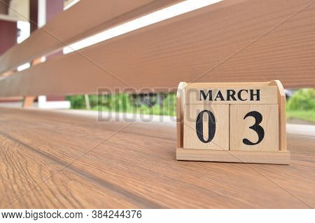 March 3, Number Cube With Wooden Balcony Background.