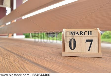 March 7, Number Cube With Wooden Balcony Background.