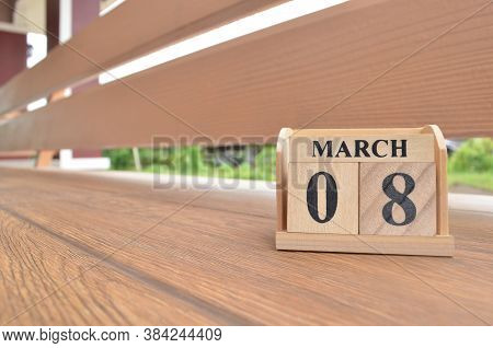 March 8, Number Cube With Wooden Balcony Background.