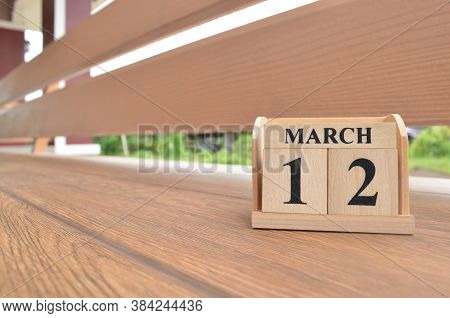 March 12, Number Cube With Wooden Balcony Background.
