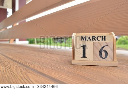 March 16, Number Cube With Wooden Balcony Background.