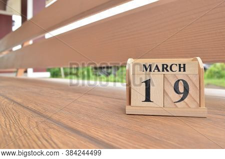 March 19, Number Cube With Wooden Balcony Background.