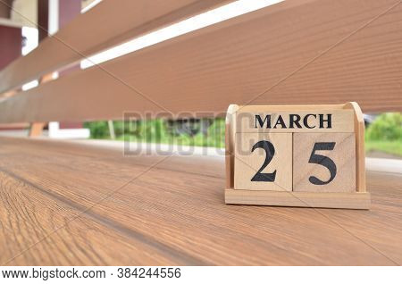 March 25, Number Cube With Wooden Balcony Background.