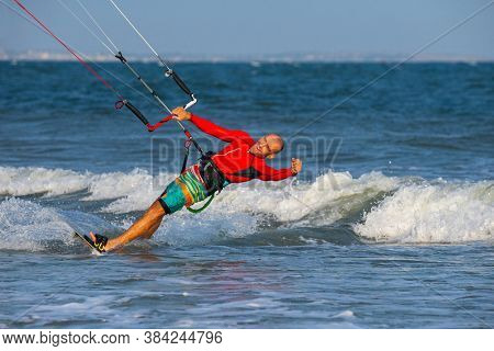 Kitesurfing on the waves of the sea in Mui Ne beach, Phan Thiet, Binh Thuan, Vietnam. Kitesurfing, Kiteboarding action photos. Kitesurf In Action 